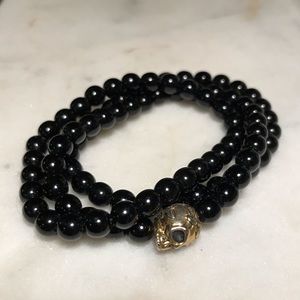 Black glass bead bracelet set with gold skull